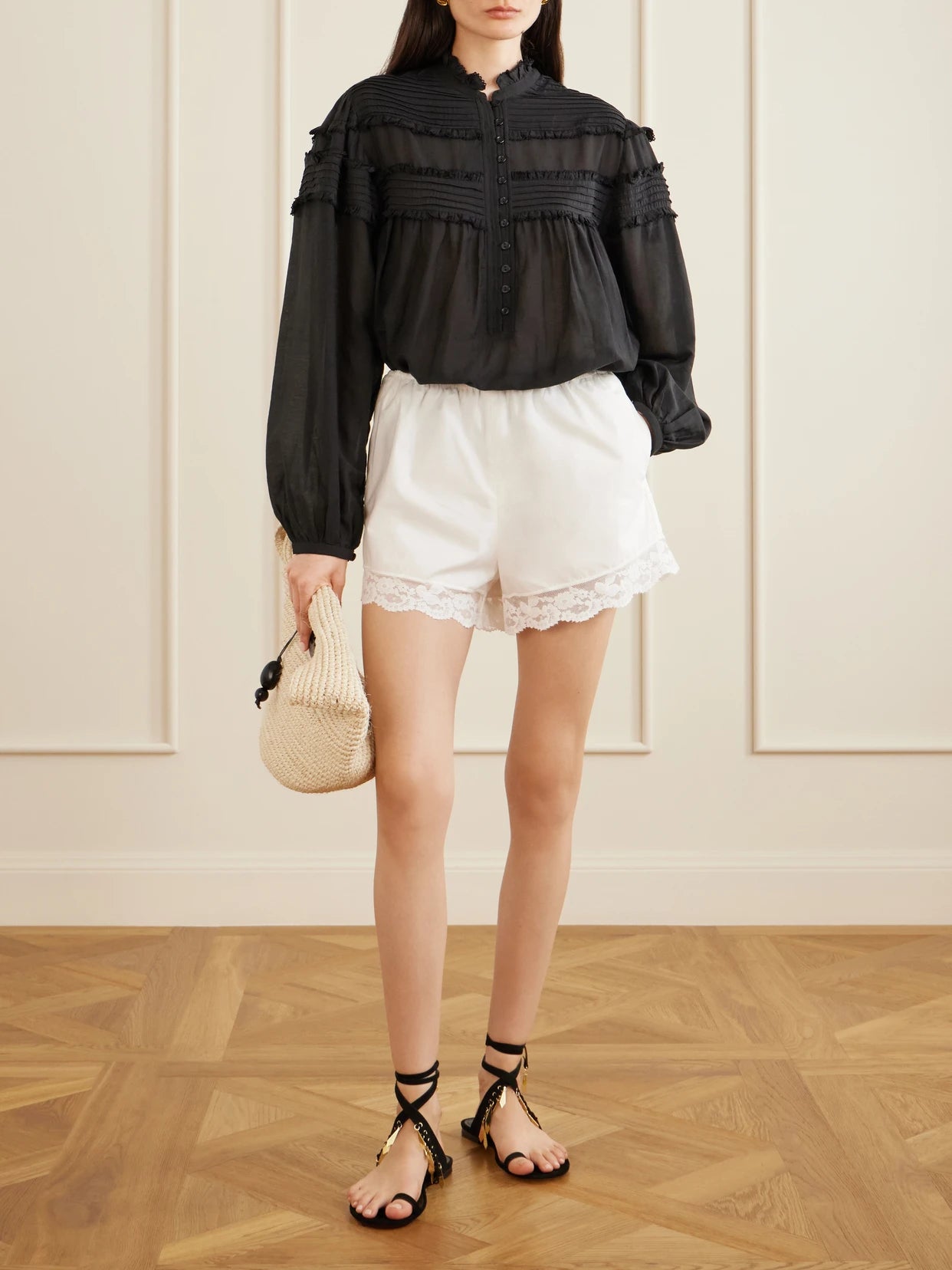 Image of a model wearing Tops. Product name - Doane Ruffled Cotton-blend Voile Blouse in Black colour by brand - MARANT ÉTOILE