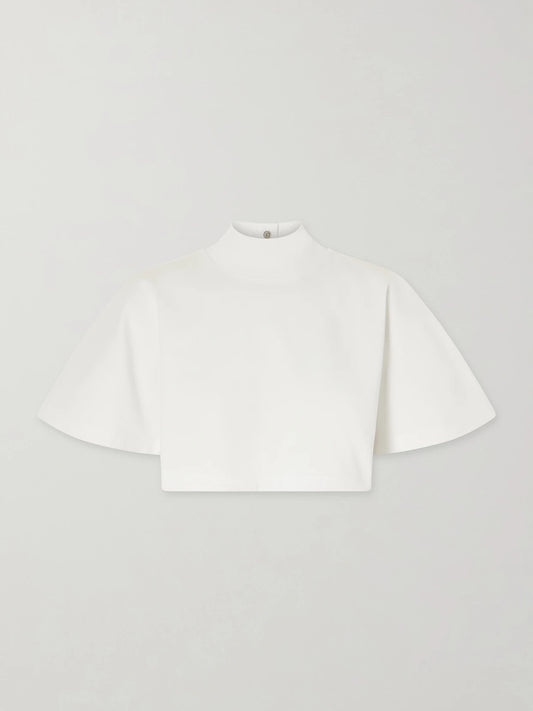 Image of a model wearing Tops. Product name - Cropped Cotton-jersey Turtleneck T-shirt in White colour by brand - Alaïa