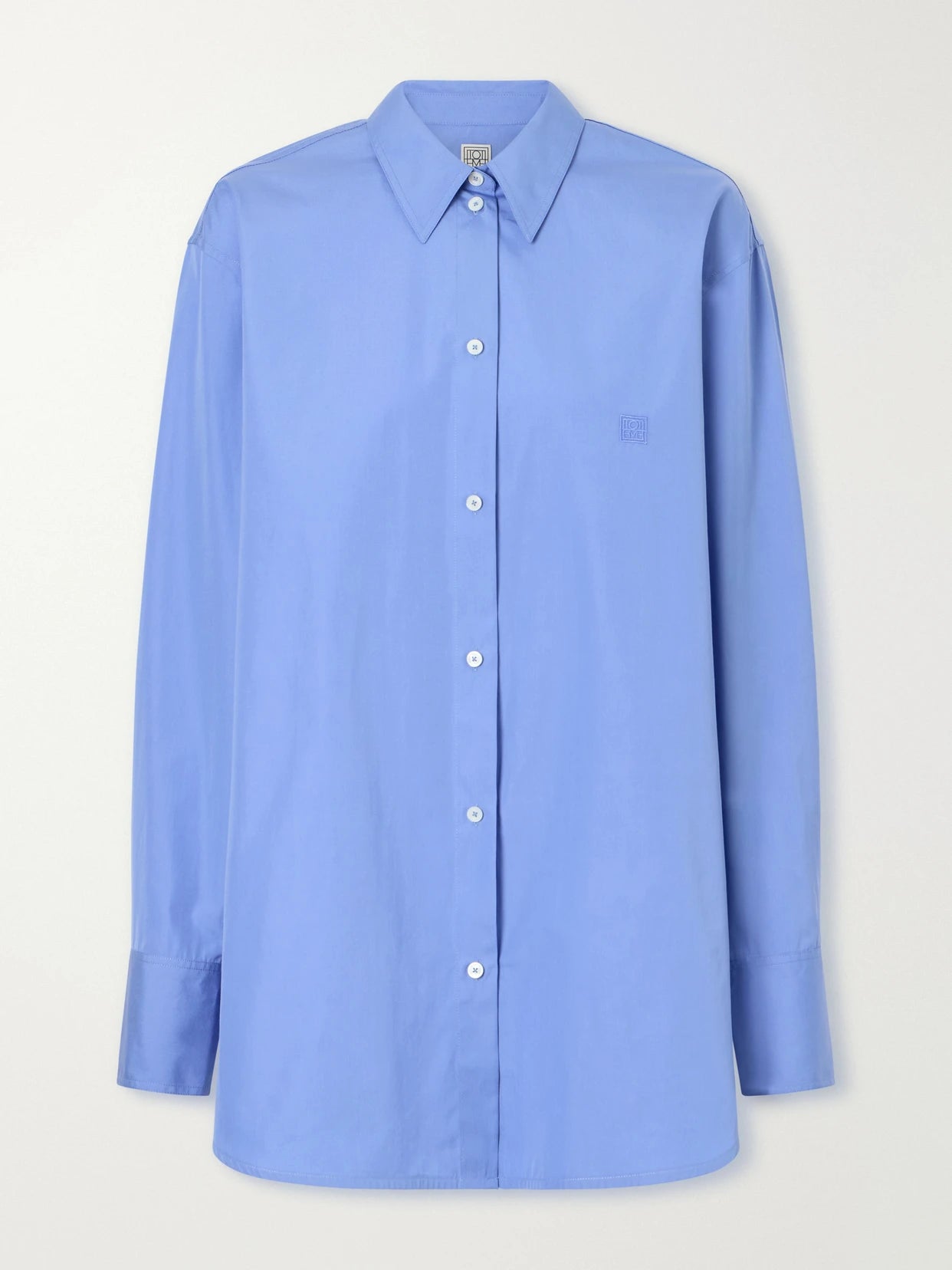 Image of a model wearing Tops. Product name - Embroidered Cotton-poplin Shirt in Blue colour by brand - TOTEME