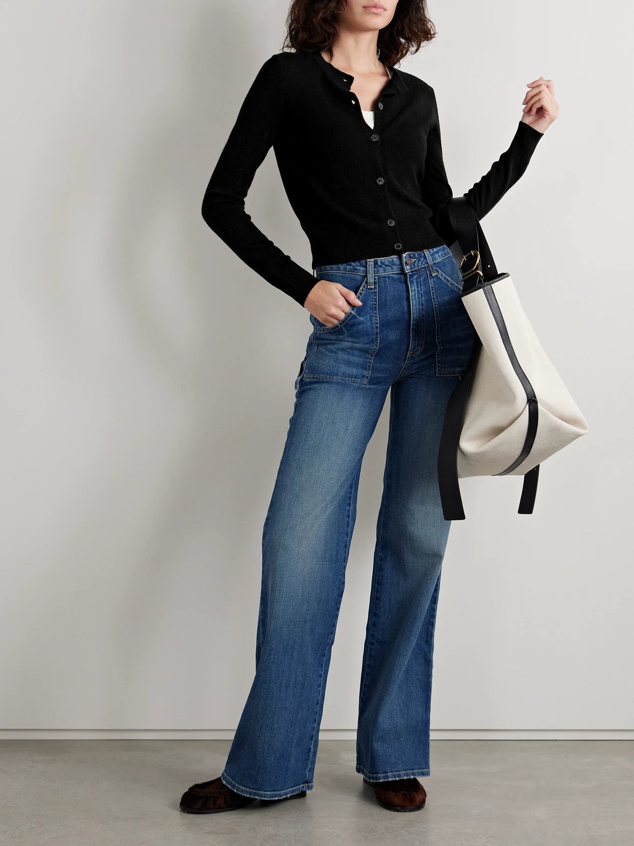 Image of a model wearing Outerwear. Product name - March Cashmere Cardigan in Black colour by brand - Nili Lotan
