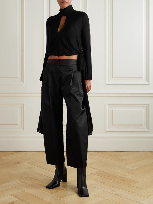 Image of a model wearing Tops. Product name - Knotted Crepe De Chine Blouse in Black colour by brand - Alaïa