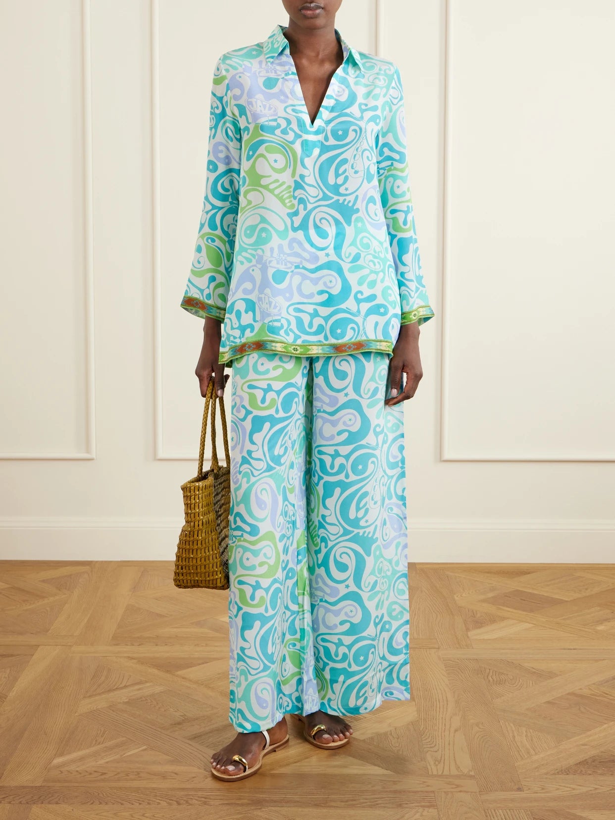 Image of a model wearing Pants. Product name - Stephan Printed Silk Wide-leg Pants in Light blue colour by brand - Emporio Sirenuse