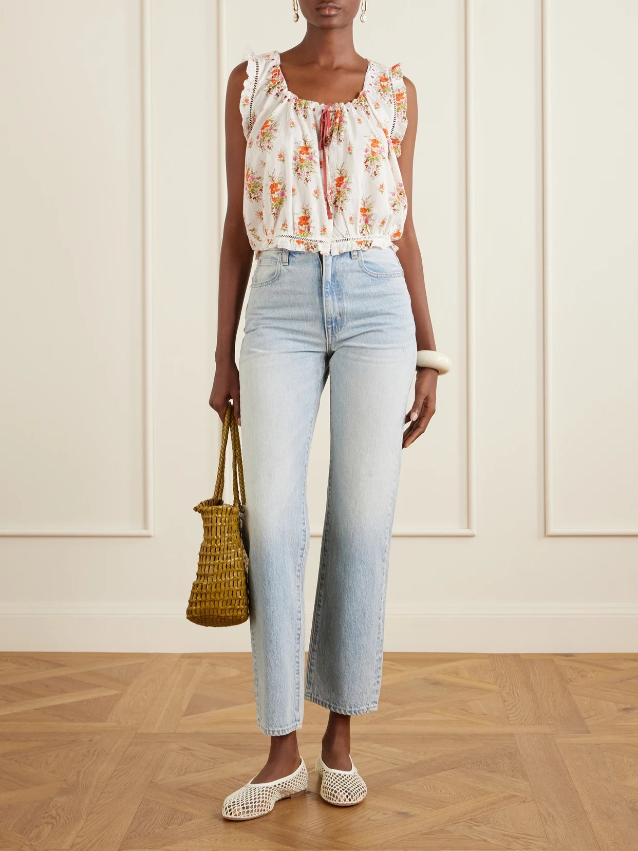 Image of a model wearing Tops. Product name - Traveler Embroidered Floral-print Organic Cotton Blouse in White colour by brand - DÔEN