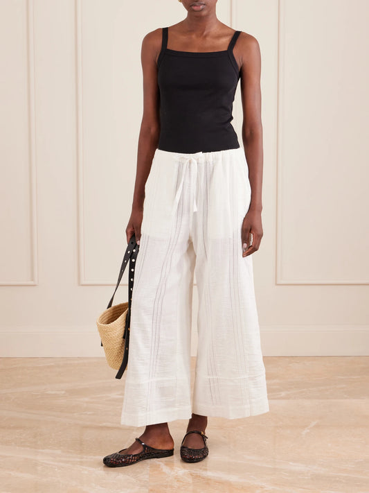 Image of a model wearing Pants. Product name - Desta Striped Cotton Wide-leg Pants in White colour by brand - lemlem