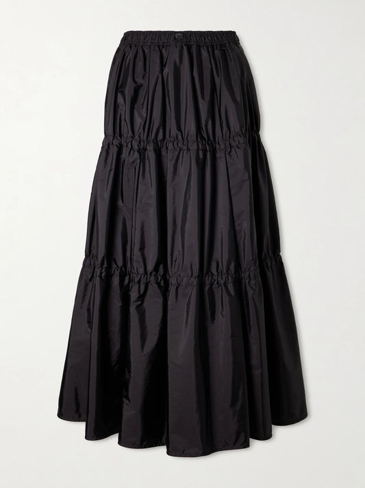 Image of a model wearing Skirts. Product name - Tiered Shell Midi Skirt in Black colour by brand - Moncler
