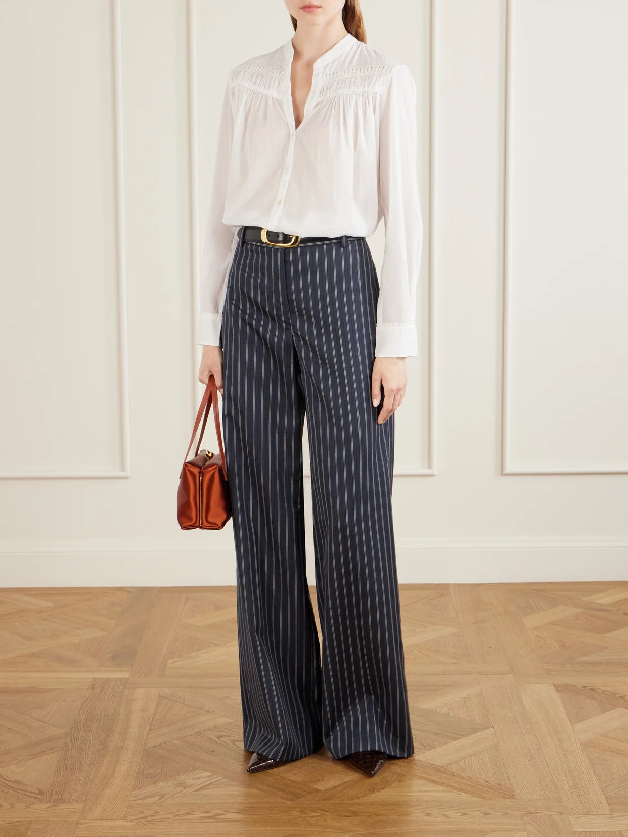 Image of a model wearing Pants. Product name - Rivers Striped Wool Wide-leg Pants in Navy colour by brand - Nili Lotan
