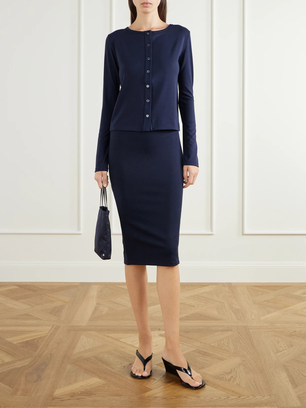 Image of a model wearing Skirts. Product name - Sheryl Pyratex Power 3 Stretch-jersey Midi Skirt in Navy colour by brand - THE PARK