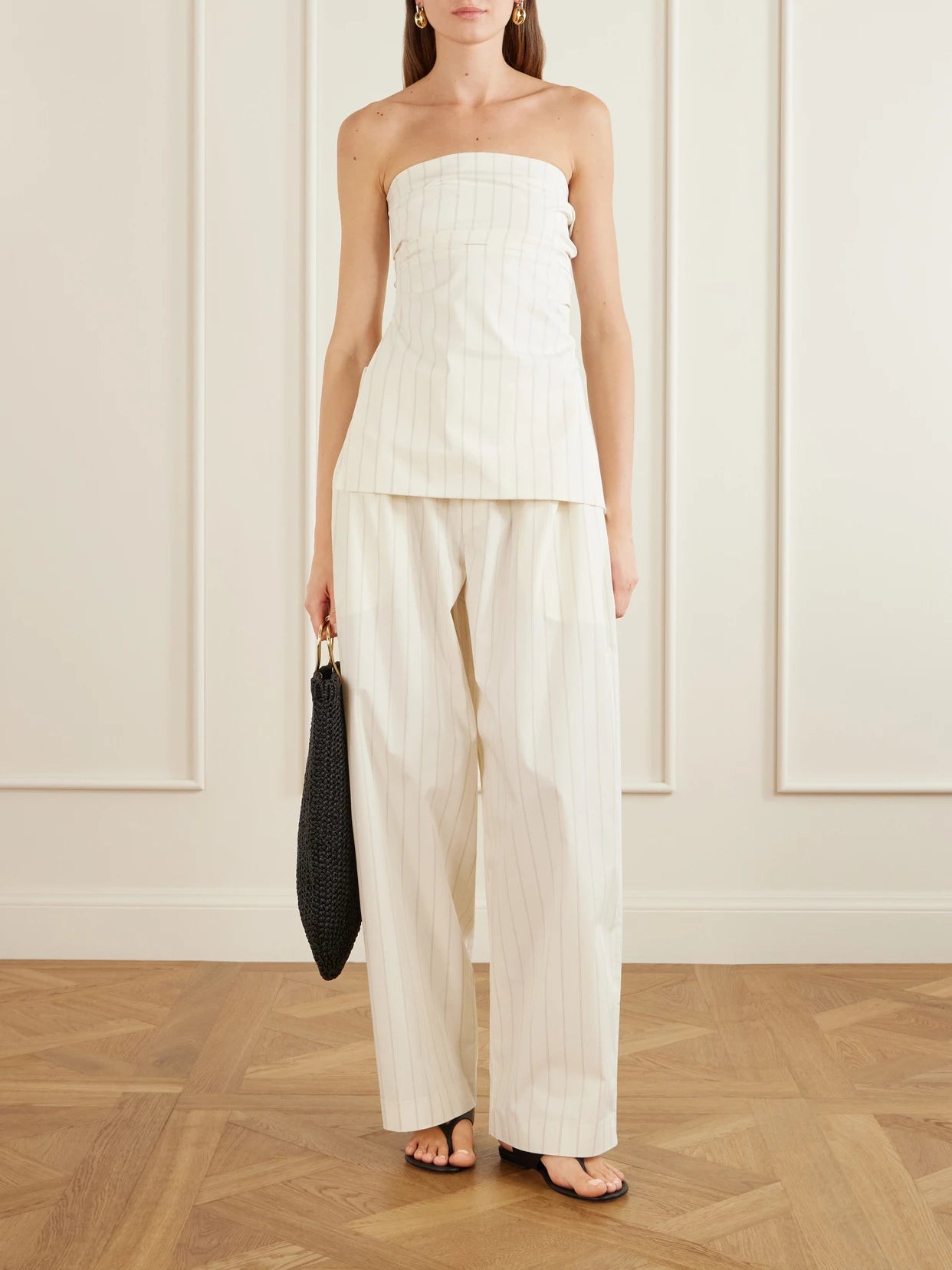 Image of a model wearing Tops. Product name - Strapless Pinstriped Cotton-blend Poplin Top in Ecru colour by brand - ST. AGNI