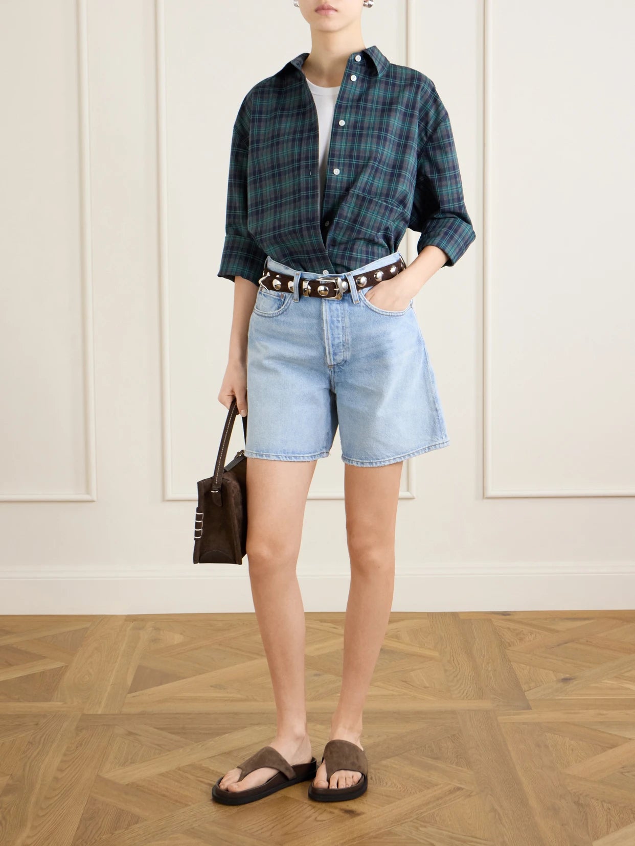 Image of a model wearing Shorts. Product name - Dame Denim Shorts in Mid denim colour by brand - AGOLDE