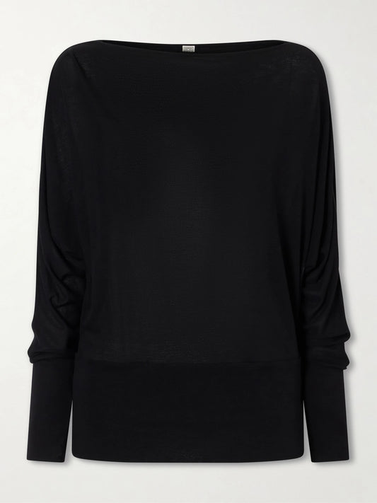 Image of a model wearing Tops. Product name - Boatneck Jersey Top in Black colour by brand - TOTEME