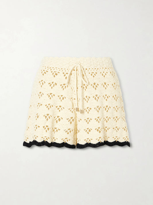Image of a model wearing Shorts. Product name - Aster Crochet Cotton Shorts in Cream colour by brand - Zimmermann