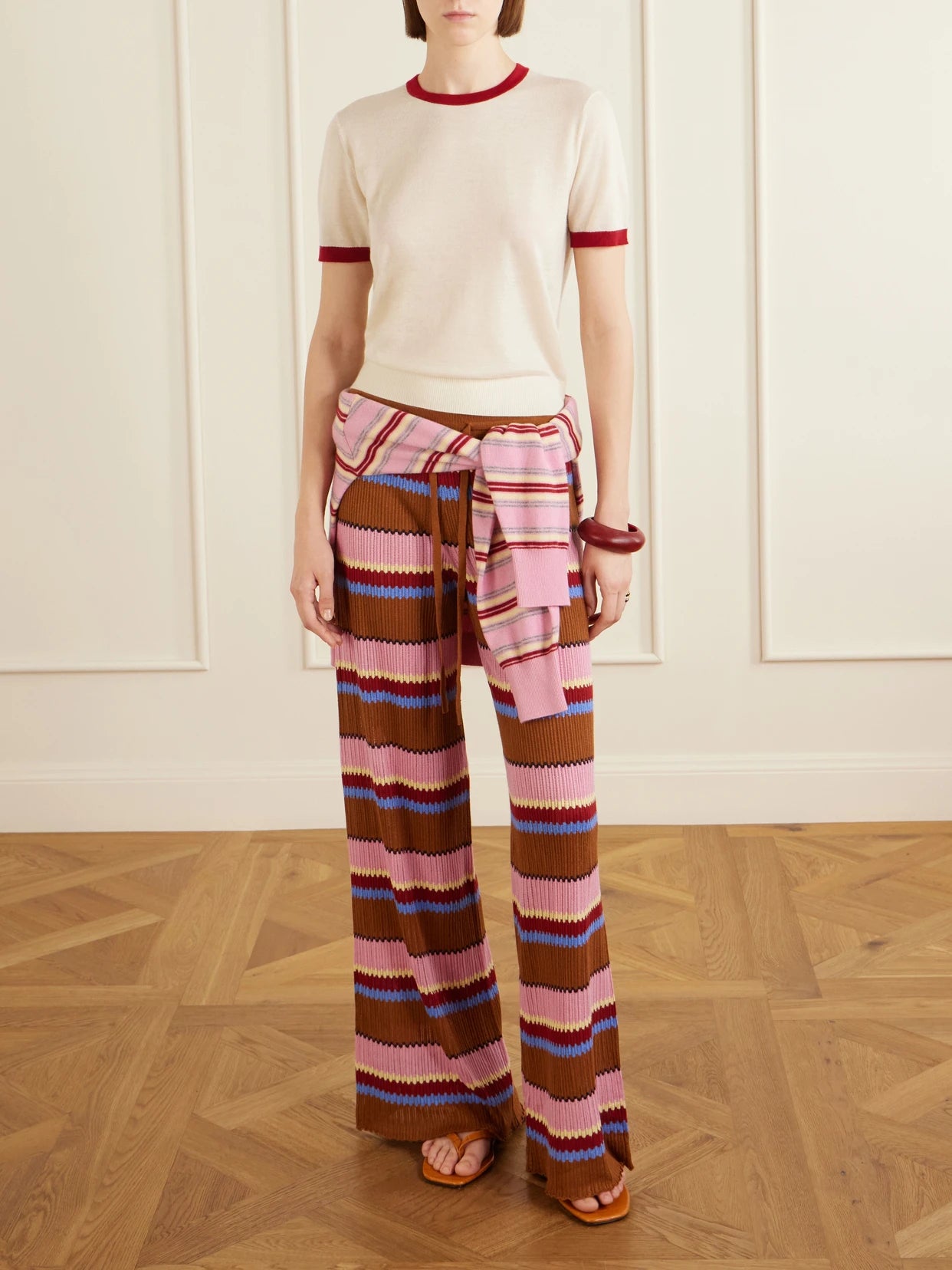 Image of a model wearing Tops. Product name - Airy Ringer Cashmere T-shirt in Cream colour by brand - Guest In Residence