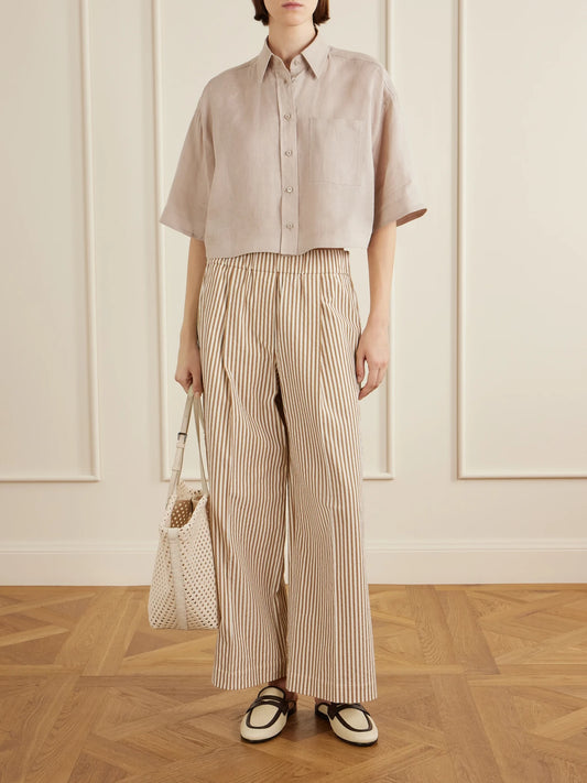 Image of a model wearing Pants. Product name - Cropped Pleated Striped Cotton-blend Wide-leg Pants in Beige colour by brand - Brunello Cucinelli