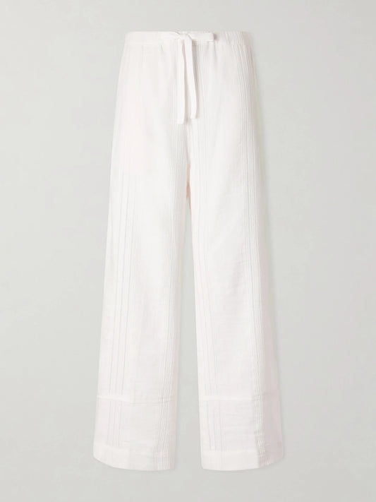 Image of a model wearing Pants. Product name - Desta Striped Cotton Wide-leg Pants in White colour by brand - lemlem