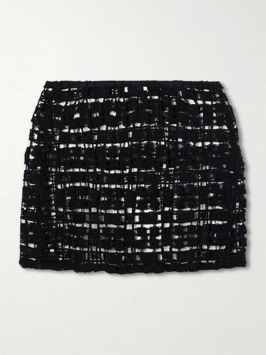 Image of a model wearing Skirts. Product name - Sun Crocheted Cotton Mini Skirt in Black colour by brand - Sara Cristina