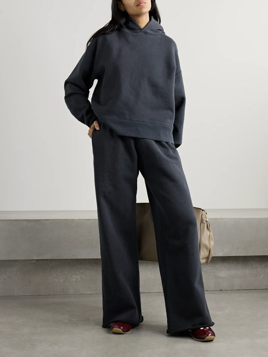Image of a model wearing Pants. Product name - Cotton-jersey Track Pants in Black colour by brand - SLVRLAKE