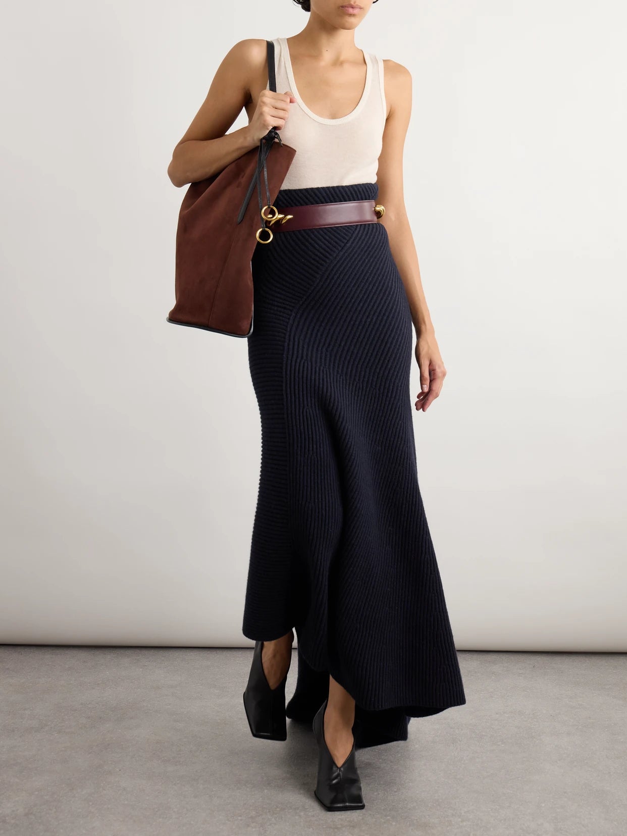 Image of a model wearing Skirts. Product name - Asymmetric Ribbed Wool And Cashmere-blend Skirt in Navy colour by brand - Alaïa