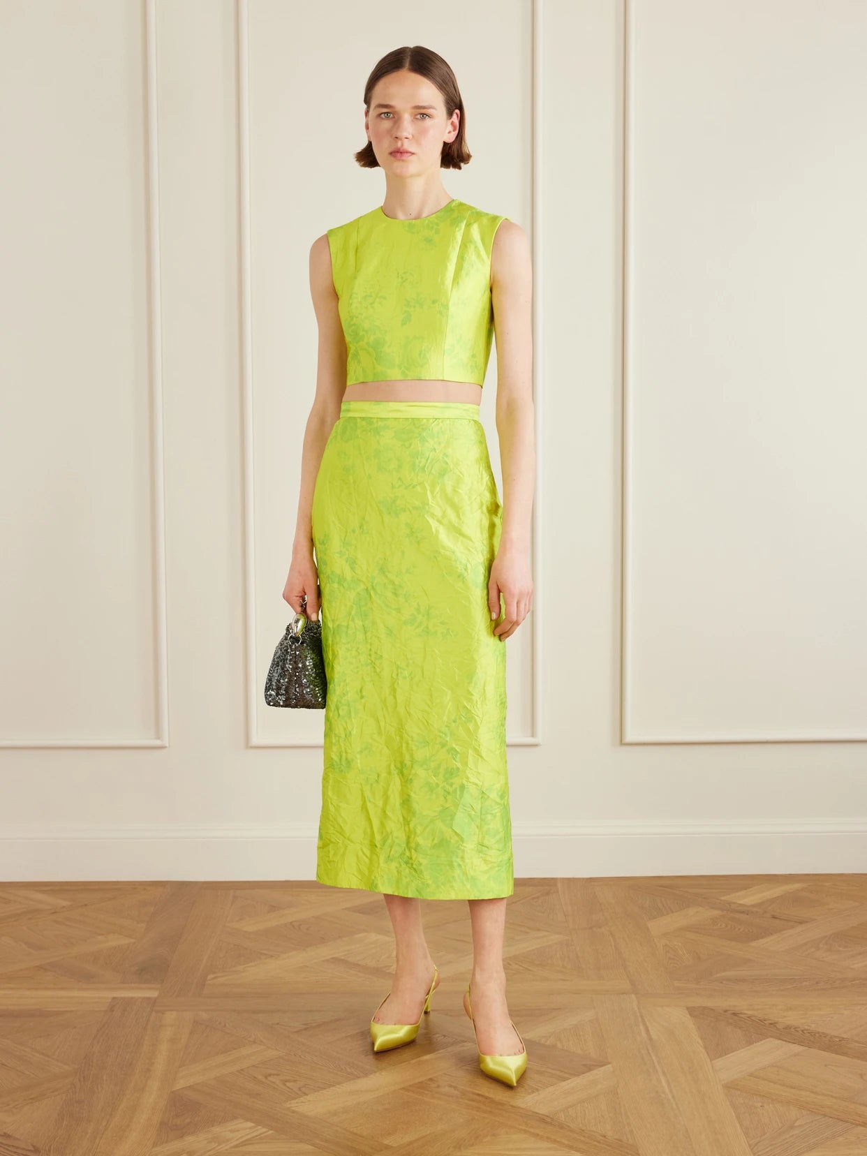 Image of a model wearing Tops. Product name - Floral-print Crinkled-satin Top in Lime green colour by brand - Erdem