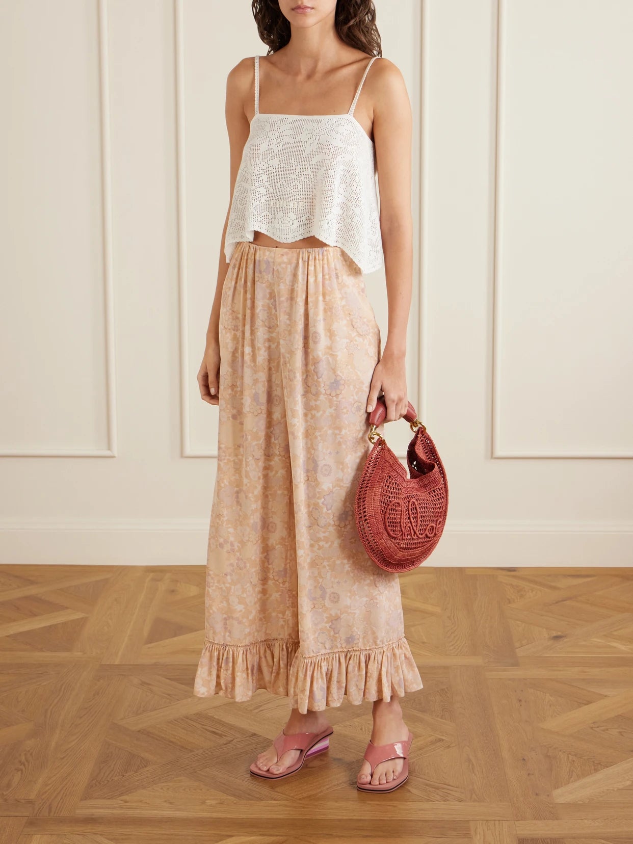 Image of a model wearing Pants. Product name - Ruffled Floral-print Silk-charmeuse Wide-leg Pants in Pink colour by brand - Chloé