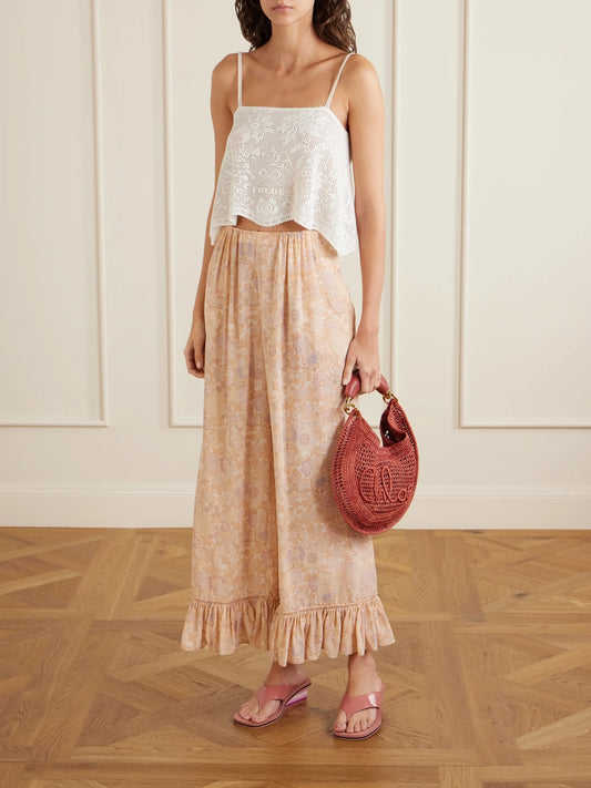 Image of a model wearing Pants. Product name - Ruffled Floral-print Silk-charmeuse Wide-leg Pants in Pink colour by brand - Chloé