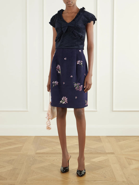 Image of a model wearing Tops. Product name - Crisscross Cropped Bow-detailed Ruffled Velvet Top in Navy colour by brand - SHUSHU/TONG