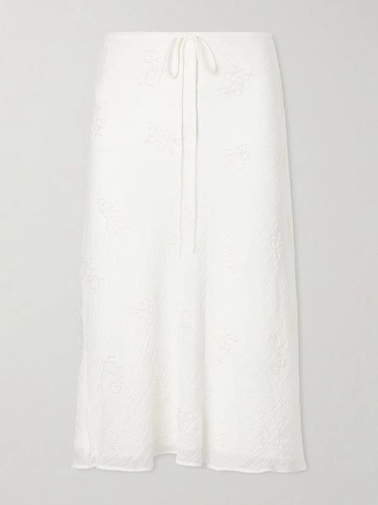 Image of a model wearing Skirts. Product name - Lucia Bead-embellished Crinkled Modal-blend Organza Midi Skirt in White colour by brand - STAUD