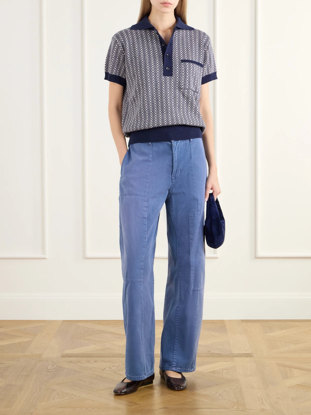 Image of a model wearing Outerwear. Product name - Lessi Jacquard-knit Cotton Polo Shirt in Navy colour by brand - ALIX OF BOHEMIA