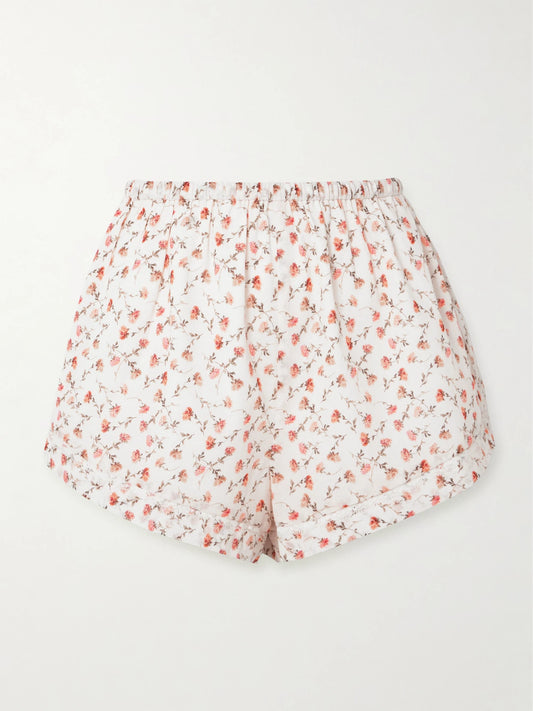 Image of a model wearing Shorts. Product name - Charlotte Lace-trimmed Floral-print Cotton Shorts in White colour by brand - Posse