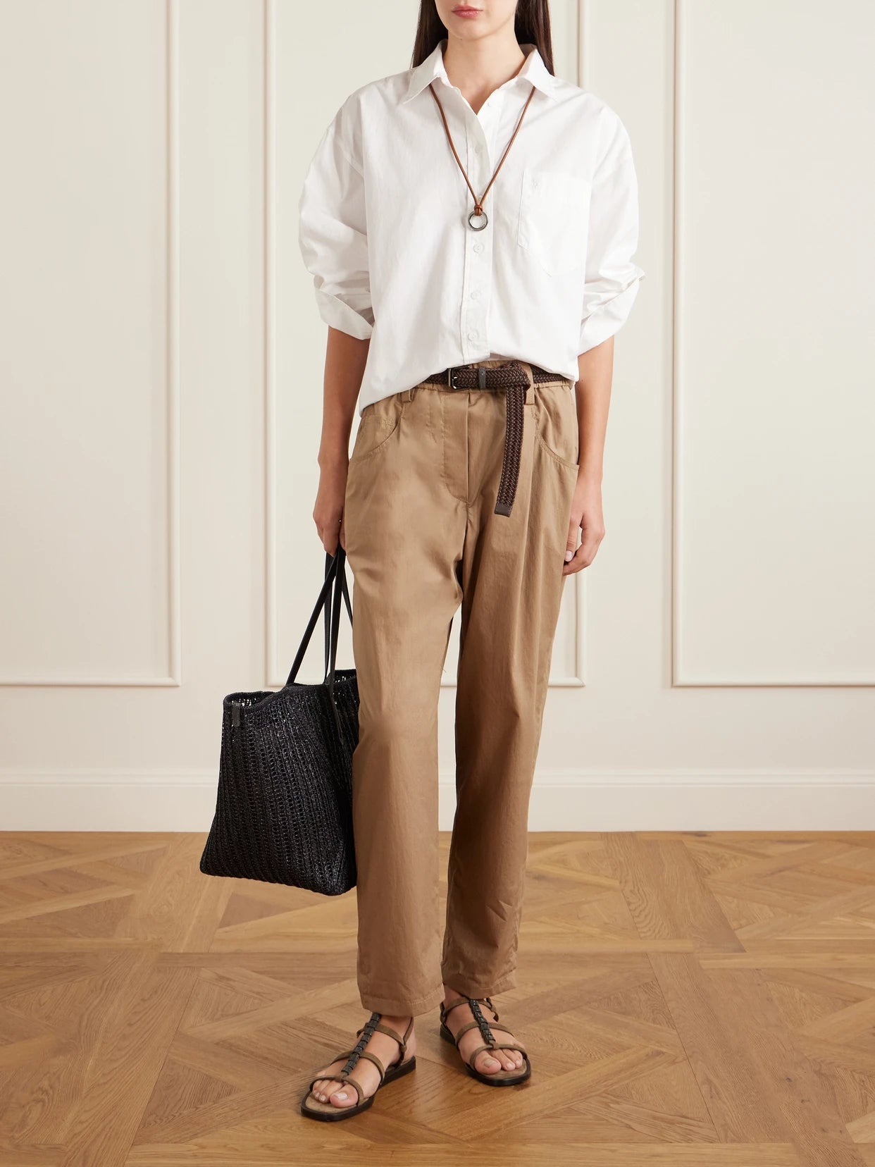 Image of a model wearing Pants. Product name - Cotton-voile Tapered Pants in Beige colour by brand - Brunello Cucinelli