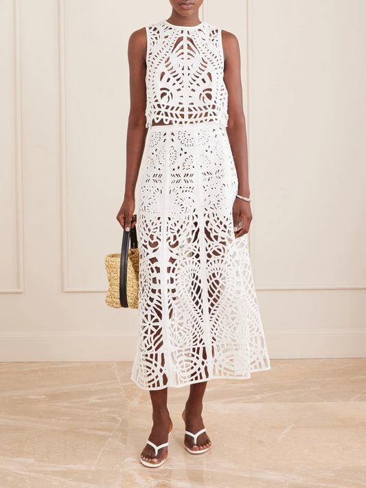 Image of a model wearing Skirts. Product name - Rita Brisé Embroidered Cotton Midi Skirt in White colour by brand - Emporio Sirenuse