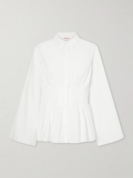 Image of a model wearing Tops. Product name - Boogie Woogie Bugle Boy Shirred Cotton-poplin Blouse in White colour by brand - Rosie Assoulin