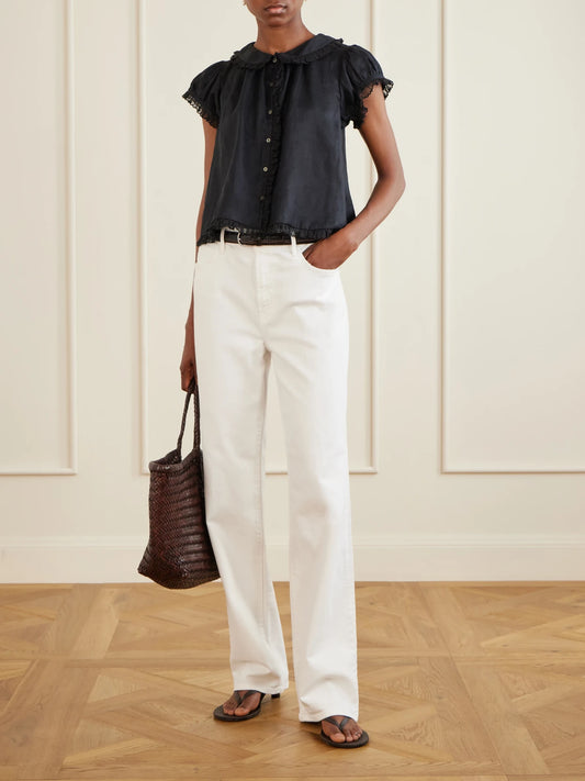 Image of a model wearing Tops. Product name - Karina Ruffled Ramie Blouse in Black, White colour by brand - DÔEN