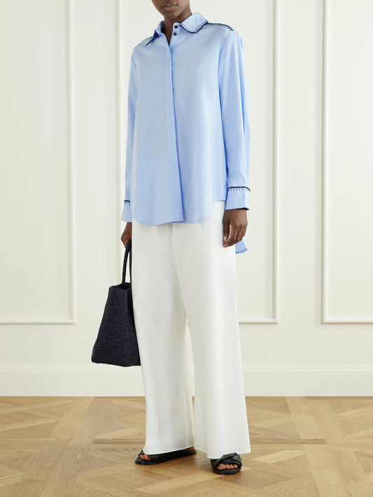 Image of a model wearing Tops. Product name - Arcangel Embroidered Cotton-poplin Shirt in Sky blue colour by brand - ESCVDO
