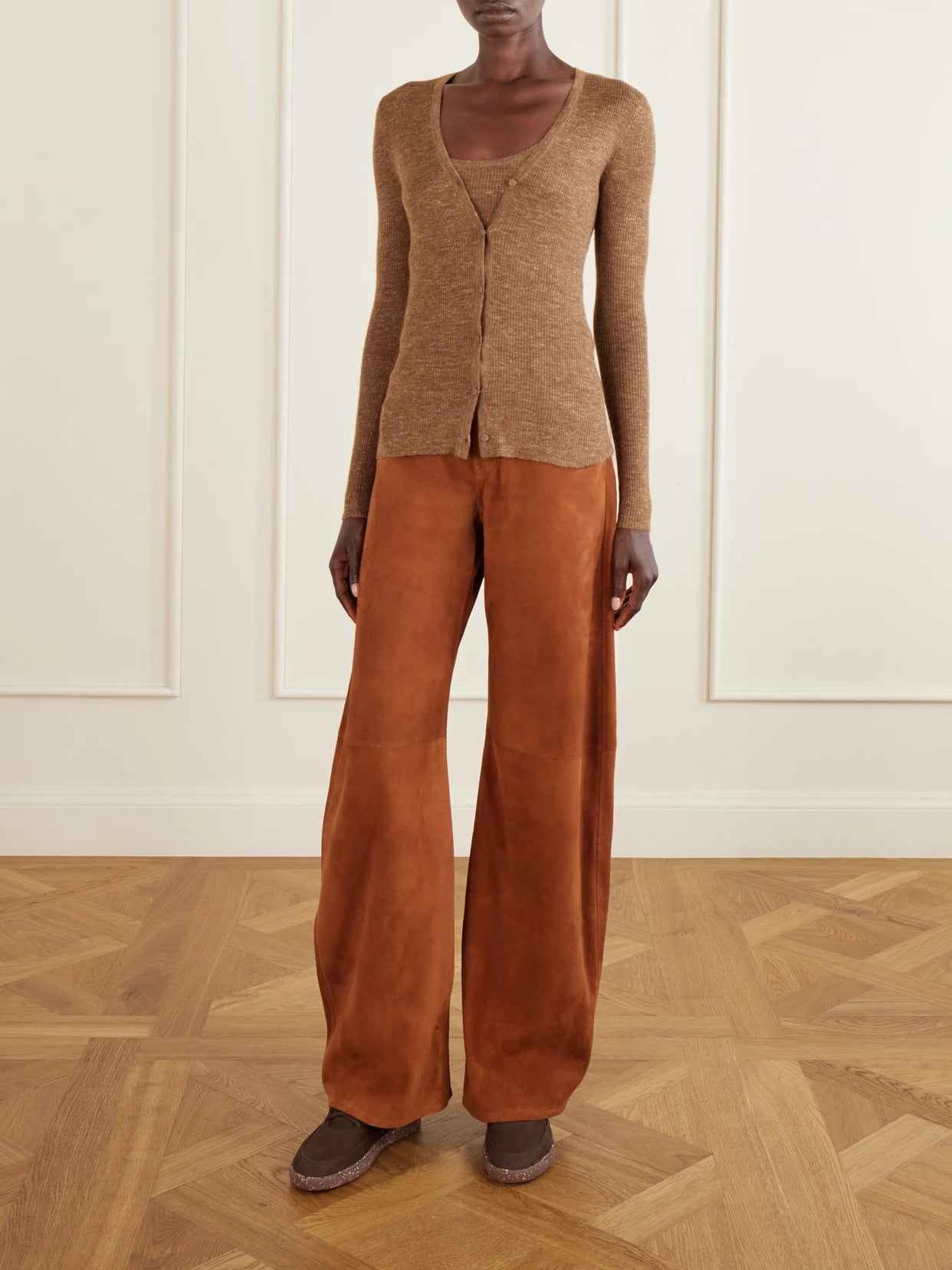 Image of a model wearing Pants. Product name - Amoret Suede Wide-leg Pants in Brown colour by brand - Gabriela Hearst