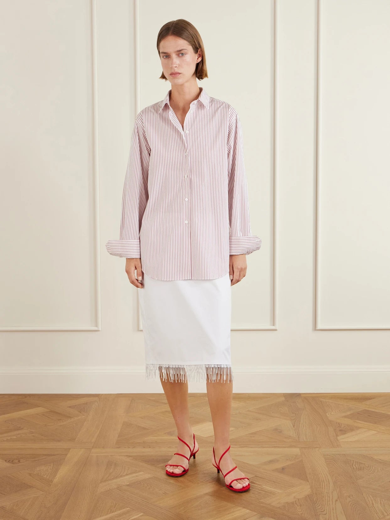 Image of a model wearing Skirts. Product name - Lace-trimmed Cotton Midi Skirt in White colour by brand - RÓHE