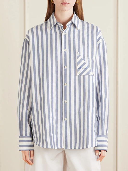 Image of a model wearing Tops. Product name - La Chemise Voilier Striped Cotton-poplin Shirt in Blue colour by brand - Jacquemus