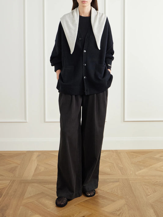 Image of a model wearing Outerwear. Product name - Tokio Cashmere-blend Cardigan in Black colour by brand - Extreme Cashmere
