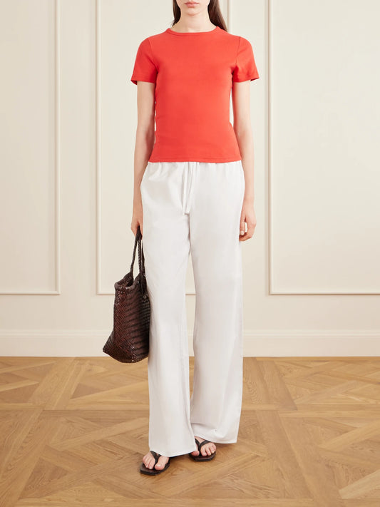 Image of a model wearing Tops. Product name - Baby Tee Cotton Shirt in Red colour by brand - Matteau