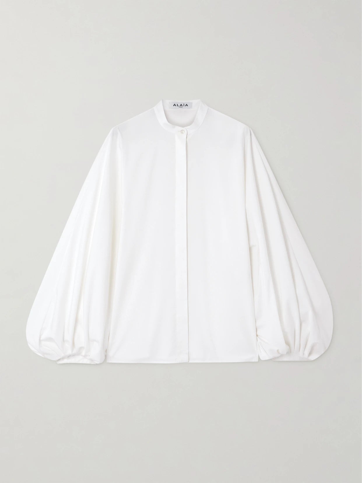 Image of a model wearing Tops. Product name - Cotton-poplin Blouse in White colour by brand - Alaïa
