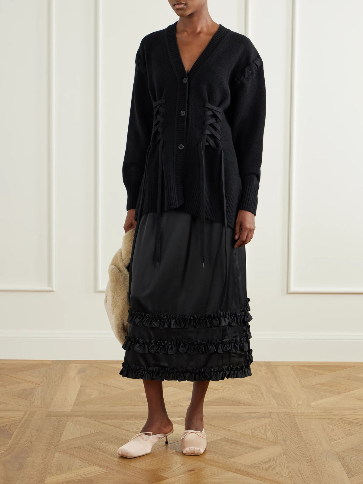 Image of a model wearing Outerwear. Product name - Sculpted Corset Merino Wool Cardigan in Black colour by brand - Simone Rocha