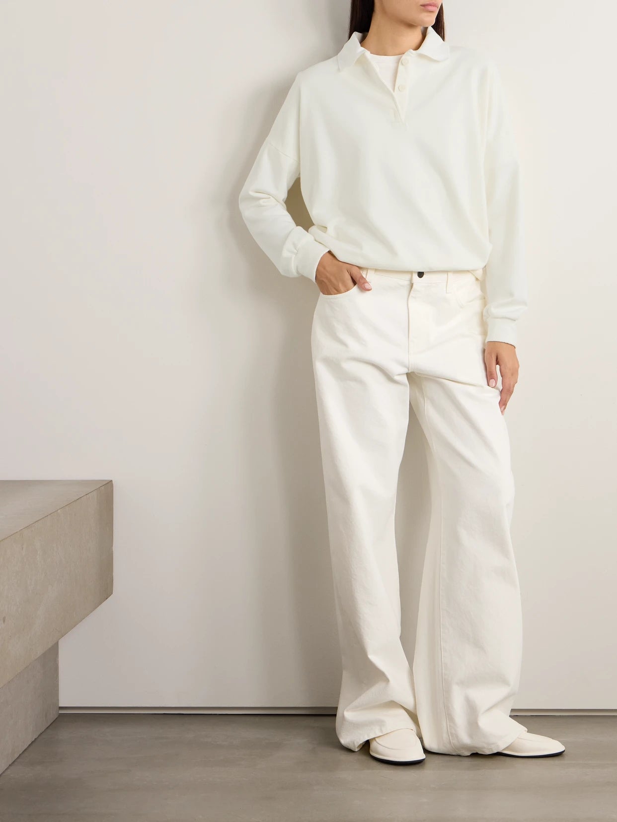 Image of a model wearing Outerwear. Product name - Essentials Corzas Cotton-terry Polo Top in Cream colour by brand - The Row