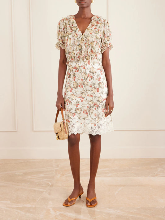 Image of a model wearing Skirts. Product name - Elowette Lace-trimmed Floral-print Silk-satin Midi Skirt in Multi colour by brand - DÔEN