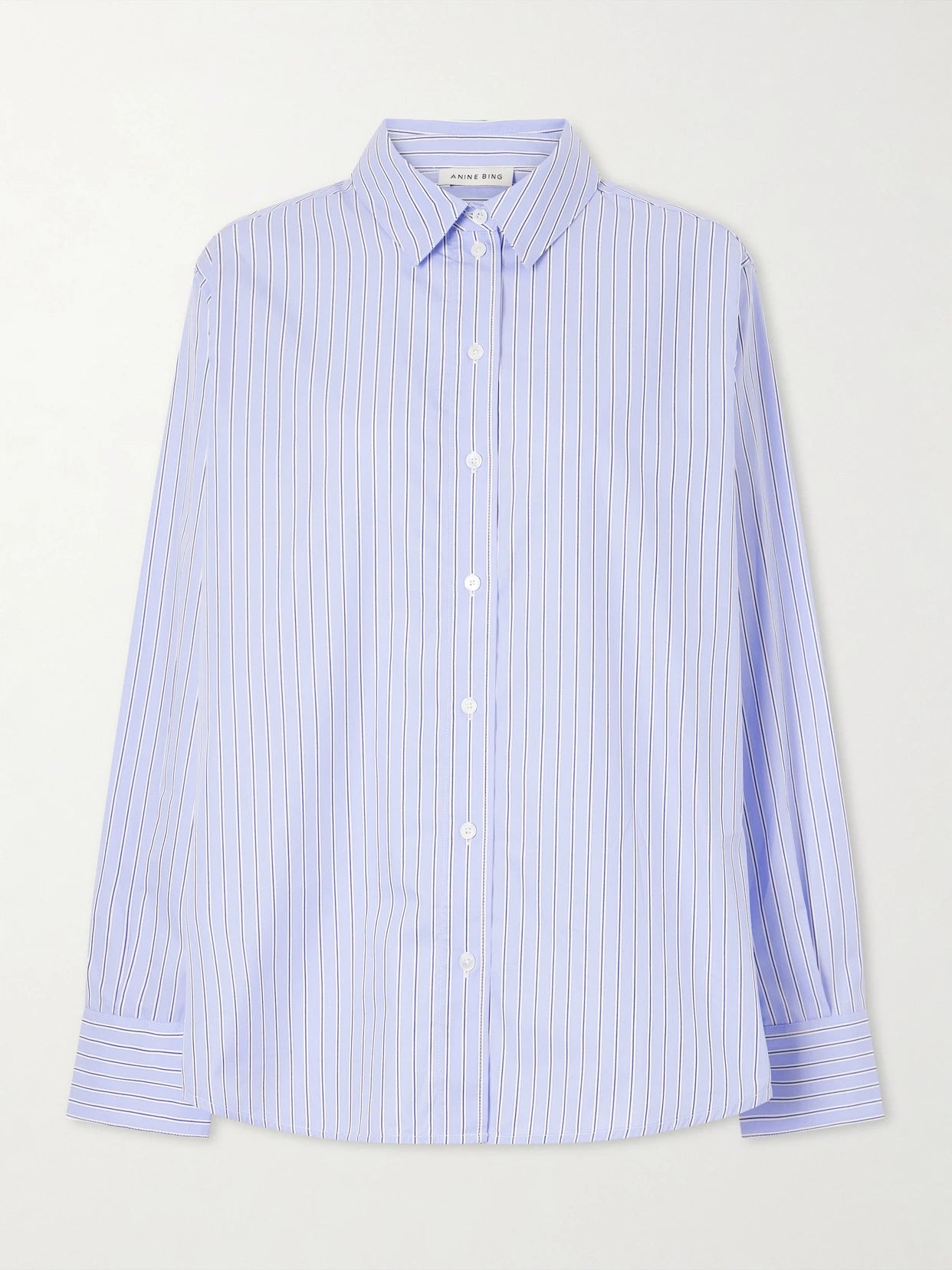 Image of a model wearing Tops. Product name - Essie Striped Cotton-poplin Shirt in Blue colour by brand - Anine Bing