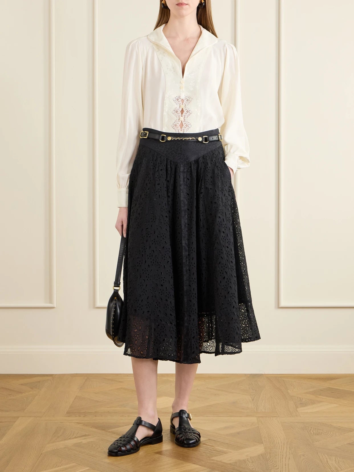 Image of a model wearing Skirts. Product name - Djuna Broderie Anglaise Silk Midi Skirt in Black colour by brand - MAISON MAYLE
