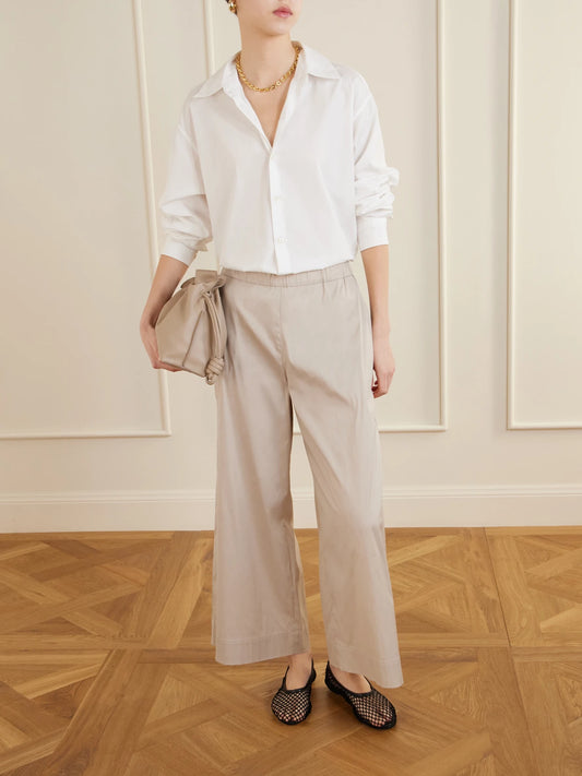 Image of a model wearing Pants. Product name - Beachwear Pece Cotton-blend Wide-leg Pants in Sand colour by brand - Max Mara