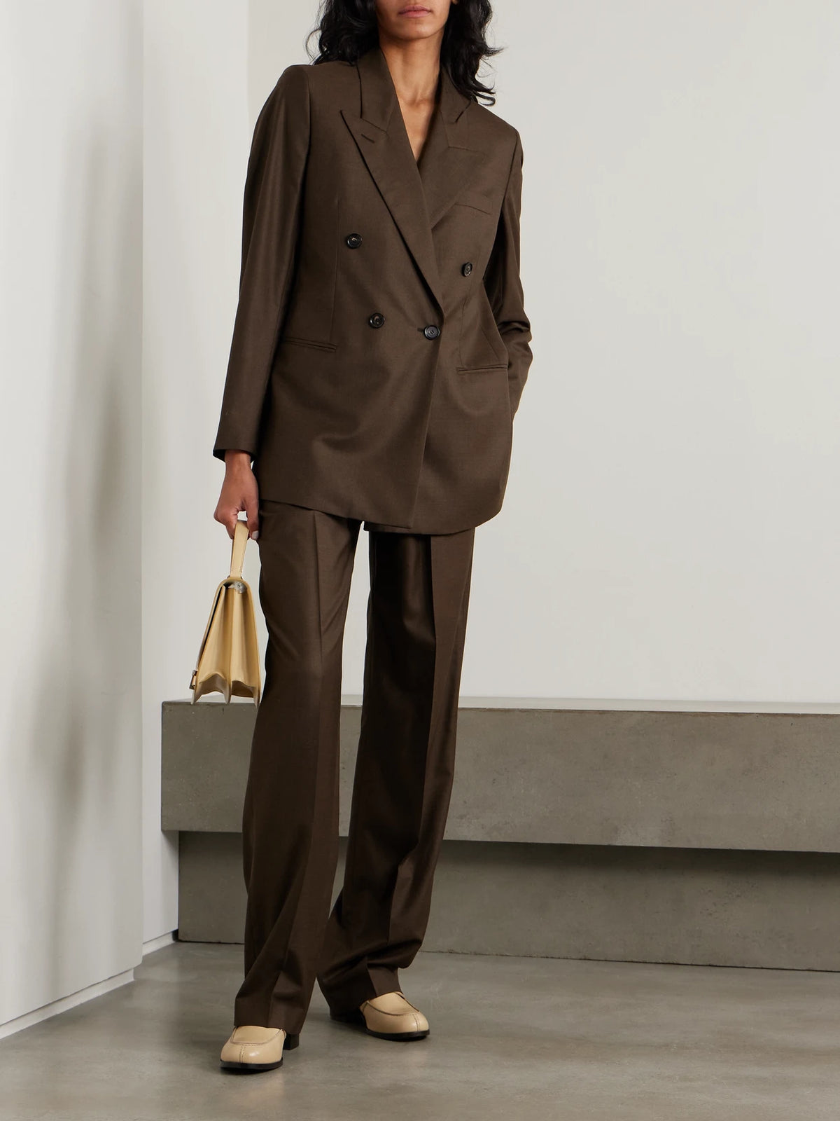 Image of a model wearing Outerwear. Product name - Oversized Double-breasted Virgin Wool Blazer in Brown colour by brand - Loro Piana