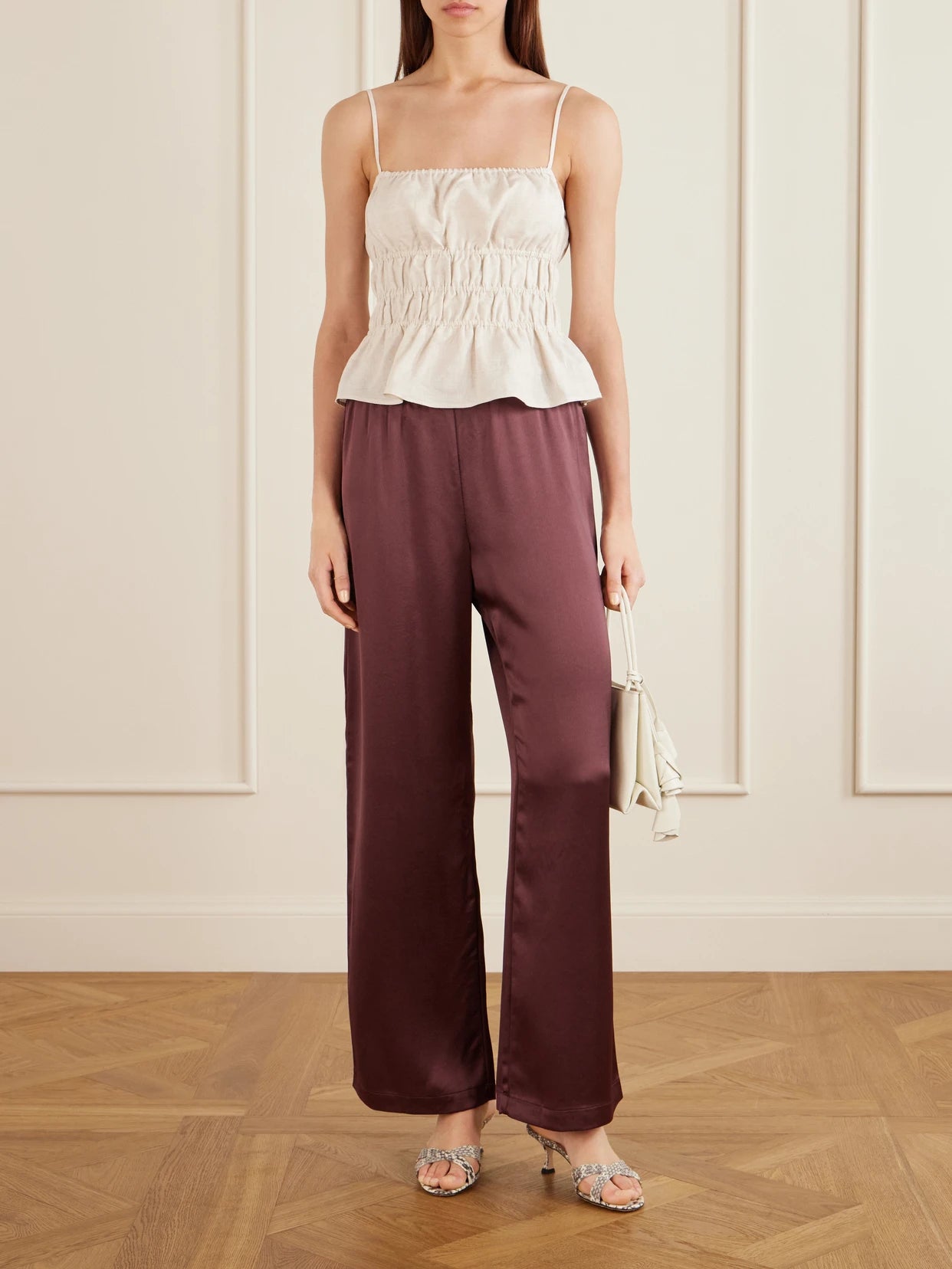 Image of a model wearing Tops. Product name - Ayla Ruffled Linen Tank in Cream colour by brand - STAUD