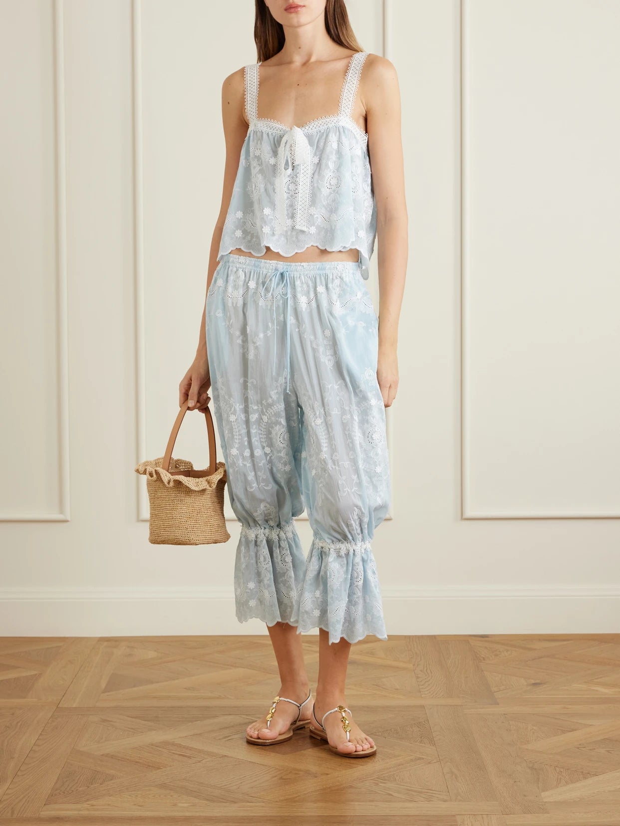 Image of a model wearing Tops. Product name - Kaila Cropped Asymmetric Bow-detailed Embroidered Silk-blend Voile Top in Blue colour by brand - Miguelina