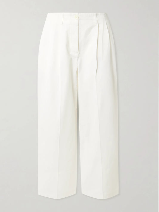 Image of a model wearing Pants. Product name - Pleated Cotton-twill Wide-leg Pants in White colour by brand - TOTEME