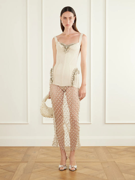Image of a model wearing Skirts. Product name - Jhanjar Embellished Cotton Crochet-knit Midi Skirt in Cream colour by brand - Yoshita 1967